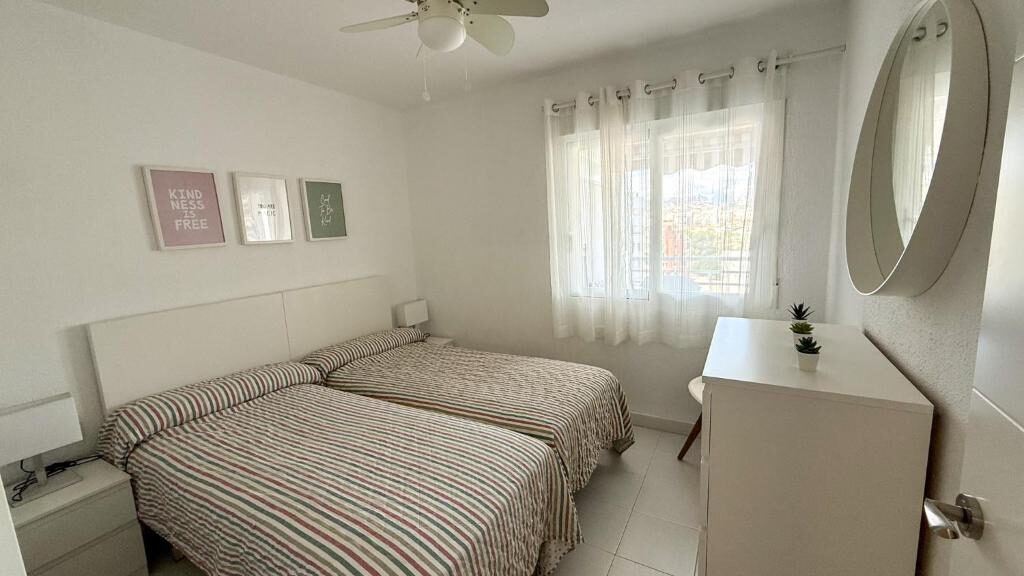 Apartment bedroom with twin beds and window